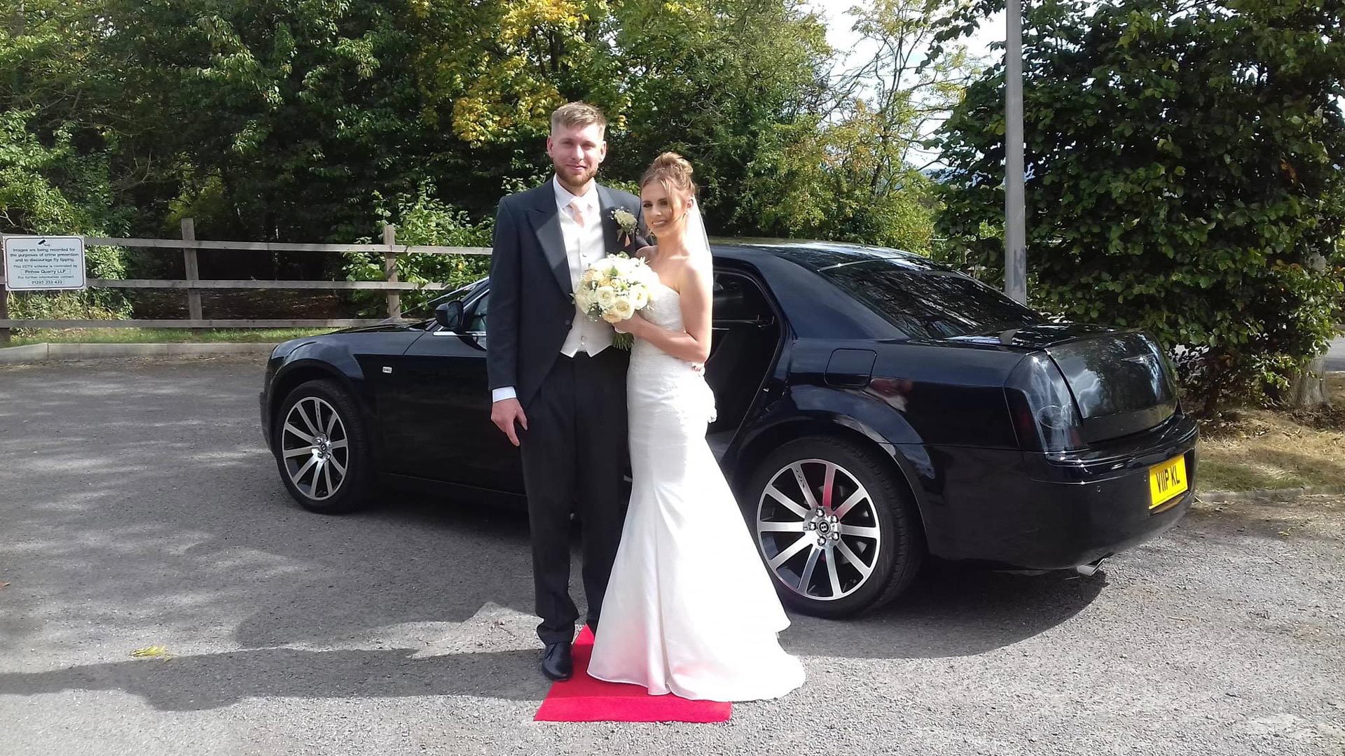 A couple outside of our baby black bentley